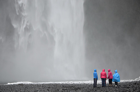 four people standing near waterfalls thumbnail