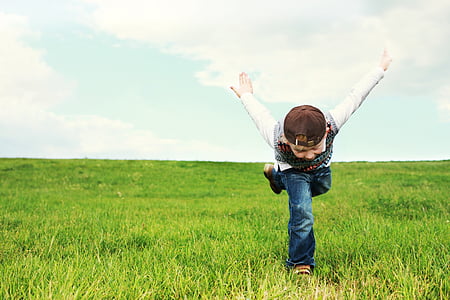 boy running like ninja on grass during daytime thumbnail