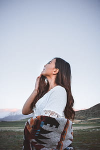 woman standing on grass field thumbnail