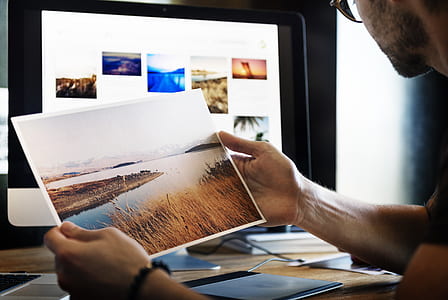 man holding a photo thumbnail