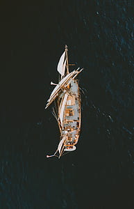 aerial photography of white and brown boat on body of water thumbnail