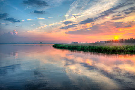grass field near body of water thumbnail