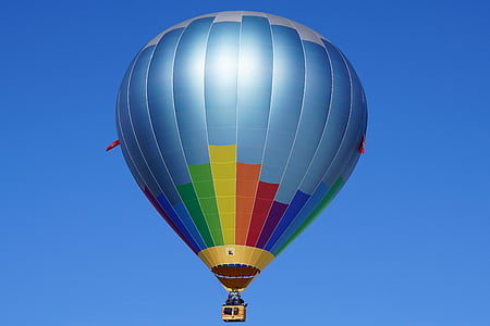 blue, yellow, and orange hot air balloon in flight at daytime thumbnail
