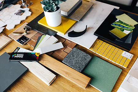 Designers working with material samples and paper cutouts thumbnail