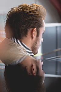 Photo of Man Wearing Beige Top With Reflection in Mirror thumbnail