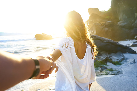 person holding a woman hand on seashore thumbnail