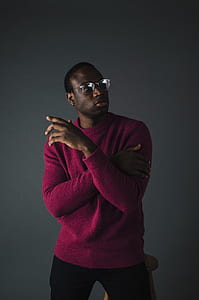 man wearing maroon sweater taking selfie while standing thumbnail