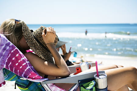 woman sun bathing at the seashore thumbnail