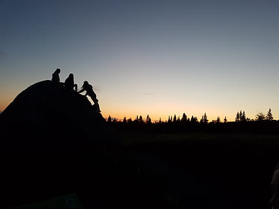 silhouette photo of three person sitting on dome thumbnail