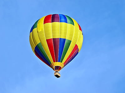 yellow and multicolored hot air balloon flying in the sky during daytime thumbnail
