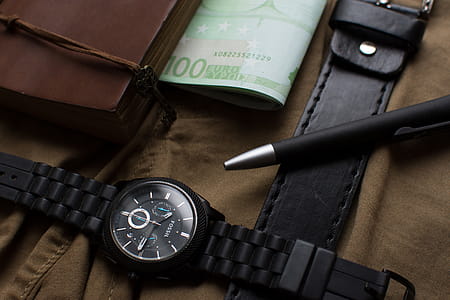 100 Euro Banknote Beside Round Black Chronograph Watch thumbnail