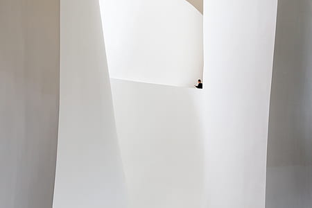 person in a black apparel standing on a ledge thumbnail