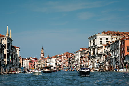 three boats sailing near buildings during daytime thumbnail
