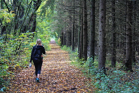 woman walking beside tree thumbnail