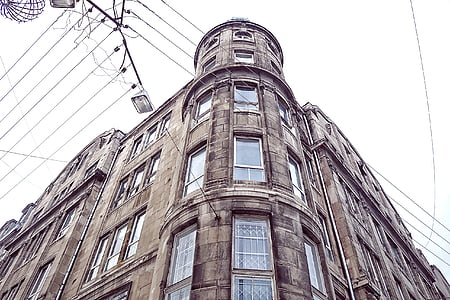 low angle photography of brown concrete building during daytime thumbnail