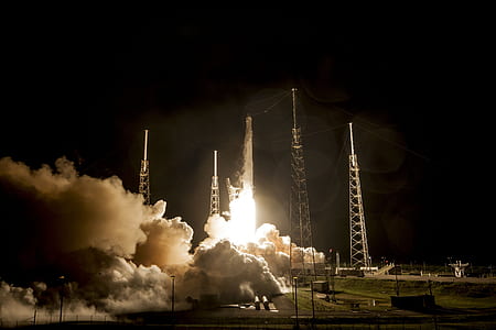 white rocket take off during nighttime thumbnail