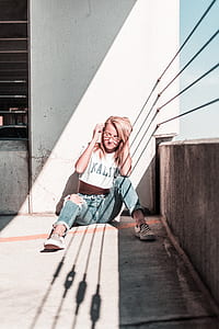 woman sitting beside balcony rail during day thumbnail