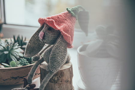 Gray Rabbit Amigurumi Plush Toy on Wood Trunk thumbnail