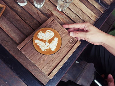 person holding cup of flavored coffee thumbnail