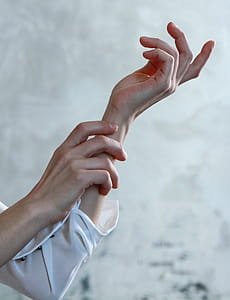 Person in White Long-sleeve Shirt With Both Hands Photo thumbnail