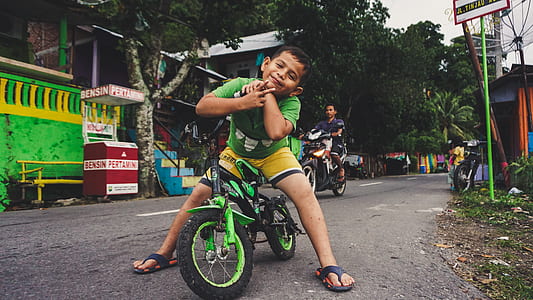 boy on green bicycle thumbnail