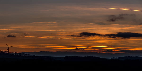 field under orange cloudy sky thumbnail