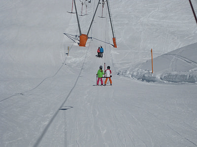 two person ski on snow field during daytime thumbnail
