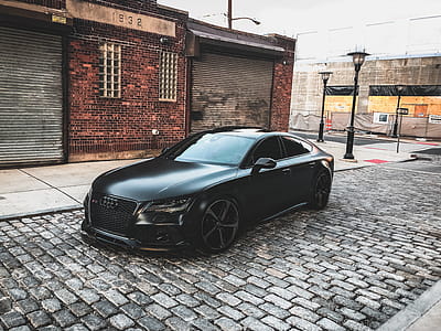 Black Audi A-series Parked Near Brown Brick House thumbnail