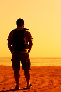 man standing in open field during daytime thumbnail