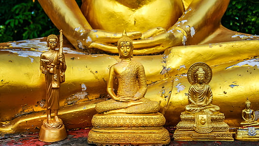 four assorted-sized of Buddha figurines thumbnail