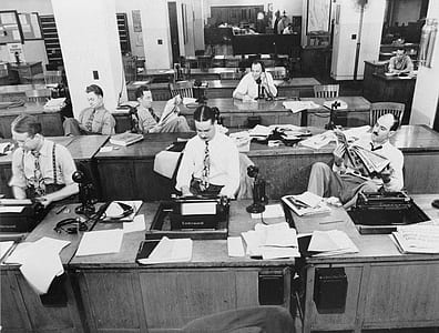 group of people on desk in gray scale thumbnail