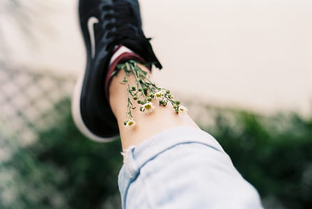 white flower on person's shoe thumbnail