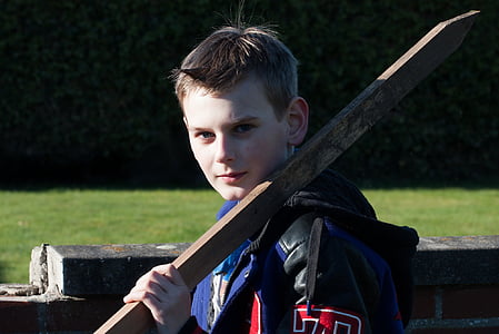 boy holding wooden stick thumbnail