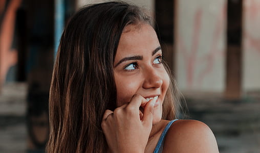woman biting her left hand thumbnail