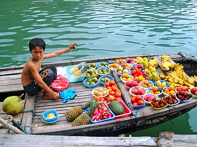 boy wearing black pants near fruits thumbnail