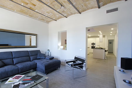 empty gray sectional couch near coffee table with magazines thumbnail