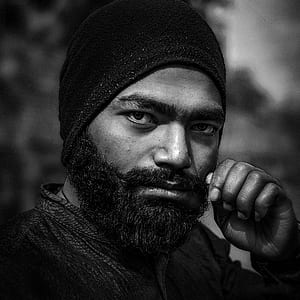shallow focus photography of man wearing beanie thumbnail
