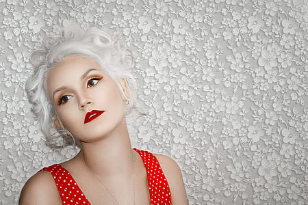woman leaning on white floral wall paint thumbnail