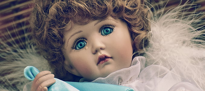 closeup photo of porcelain girl doll thumbnail