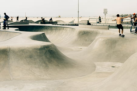 people playing skateboard in skate park thumbnail