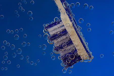 white and blue toothbrush in water thumbnail