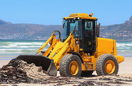 yellow front loader near shoreline thumbnail