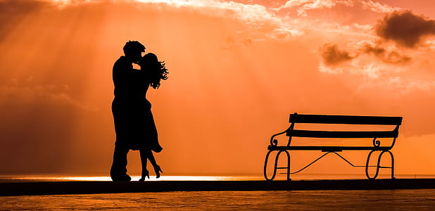 silhouette of man and woman during sunset thumbnail