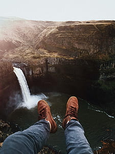 person sitting on ledge looking at the waterfalls thumbnail