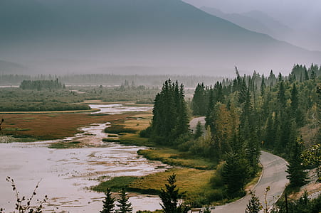 aerial photo of gray concrete road beside body of water thumbnail