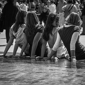 four woman wearing tops sitting beside the fountain thumbnail