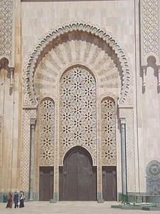 three people standing in front of concrete structure thumbnail