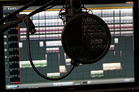 black studio condenser microphone in front of computer monitor thumbnail