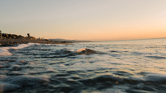 low-angle photo of seawaves beside seashore thumbnail