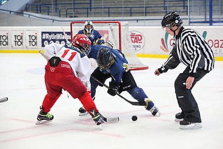 several men playing ice hockey indoors thumbnail